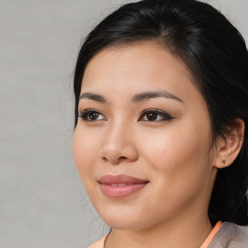 Joyful asian young-adult female with medium  brown hair and brown eyes