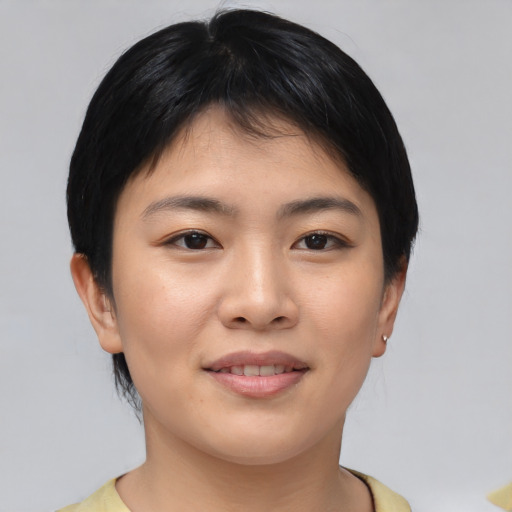 Joyful asian young-adult female with short  brown hair and brown eyes