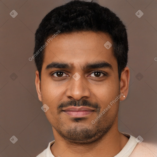 Joyful black young-adult male with short  black hair and brown eyes