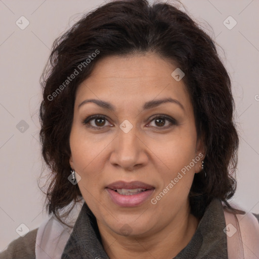 Joyful latino adult female with medium  brown hair and brown eyes