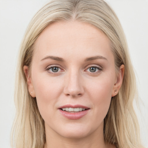 Joyful white young-adult female with long  brown hair and blue eyes