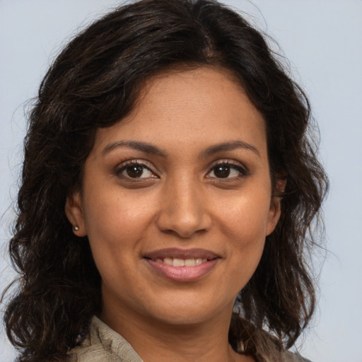 Joyful black young-adult female with medium  brown hair and brown eyes