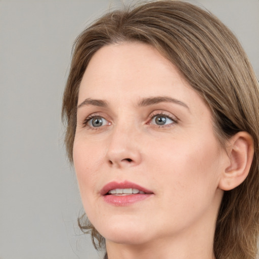 Joyful white adult female with medium  brown hair and green eyes