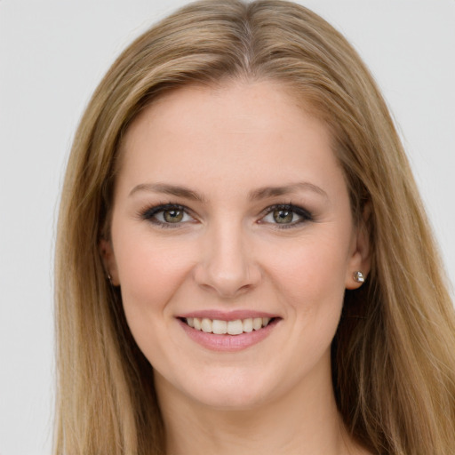 Joyful white young-adult female with long  brown hair and green eyes