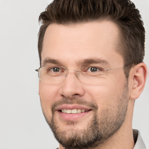 Joyful white adult male with short  brown hair and brown eyes