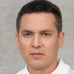 Neutral white adult male with short  black hair and brown eyes
