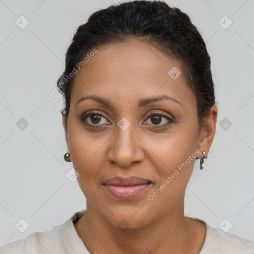 Joyful latino adult female with short  brown hair and brown eyes