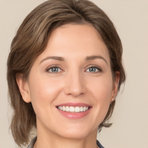 Joyful white young-adult female with medium  brown hair and green eyes