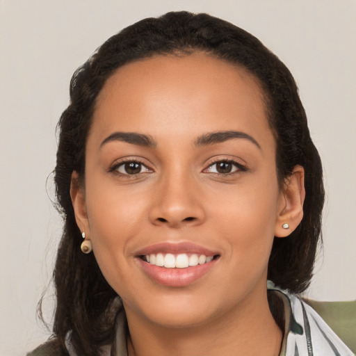 Joyful latino young-adult female with long  brown hair and brown eyes