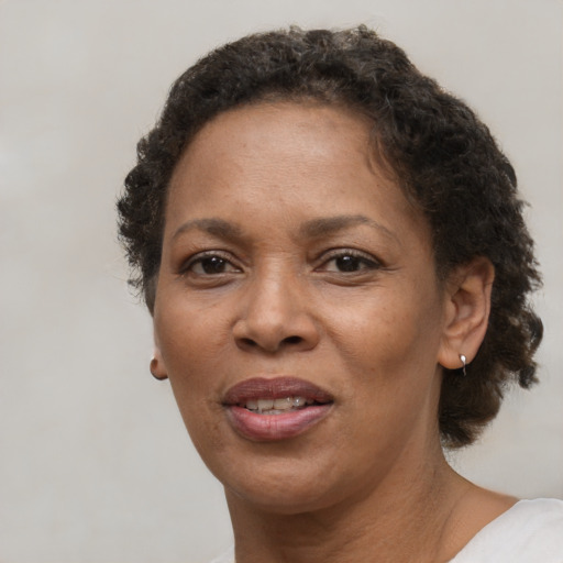 Joyful black adult female with short  brown hair and brown eyes