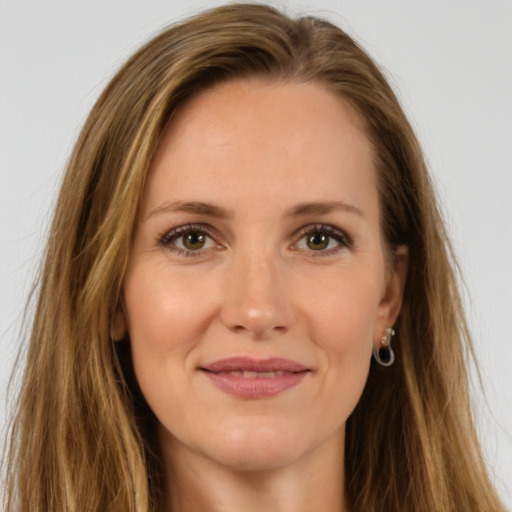 Joyful white young-adult female with long  brown hair and green eyes