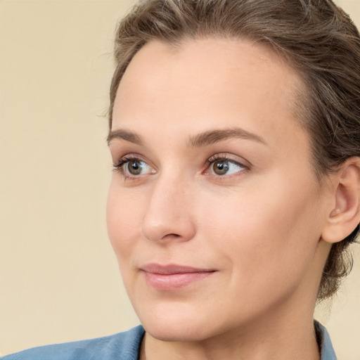 Joyful white young-adult female with medium  brown hair and blue eyes