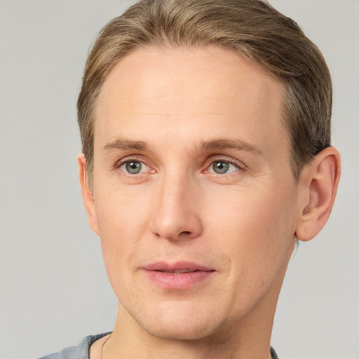 Joyful white adult male with short  brown hair and grey eyes