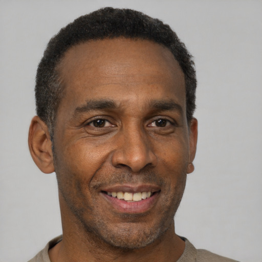 Joyful latino adult male with short  black hair and brown eyes