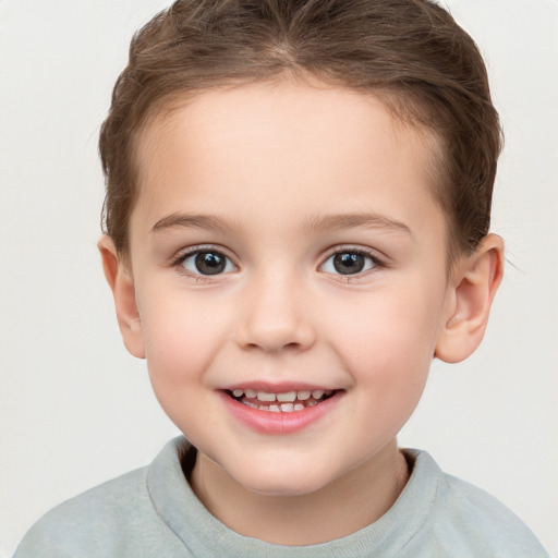 Joyful white child female with short  brown hair and brown eyes