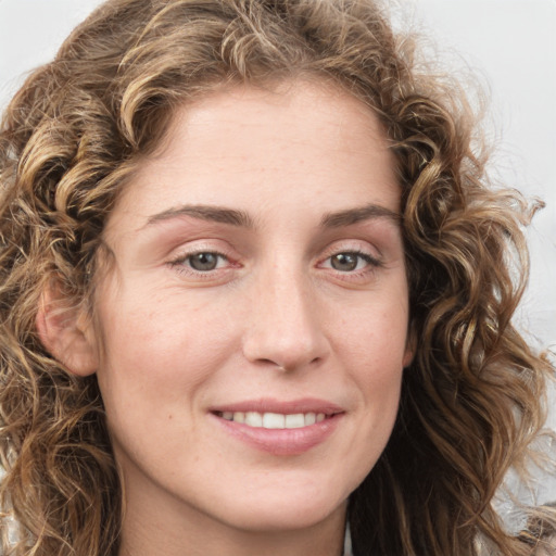 Joyful white young-adult female with long  brown hair and green eyes