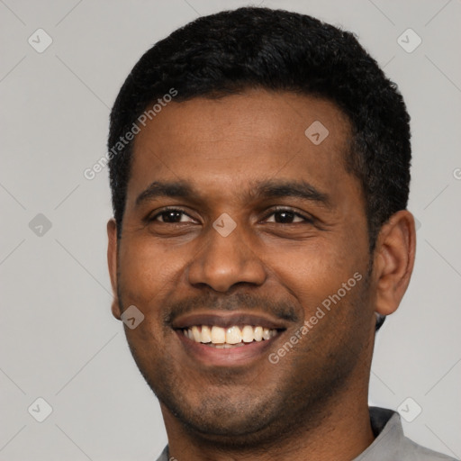 Joyful latino young-adult male with short  black hair and brown eyes