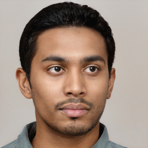 Neutral latino young-adult male with short  black hair and brown eyes