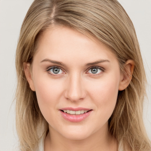 Joyful white young-adult female with long  brown hair and blue eyes