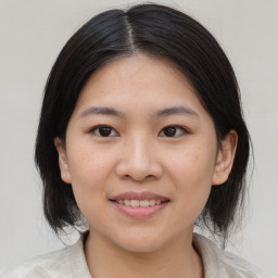 Joyful asian young-adult female with medium  black hair and brown eyes