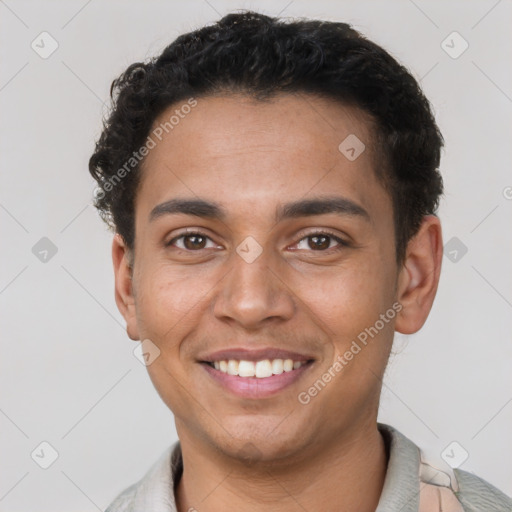 Joyful latino young-adult male with short  brown hair and brown eyes