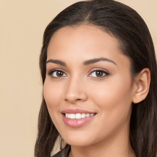 Joyful white young-adult female with long  brown hair and brown eyes