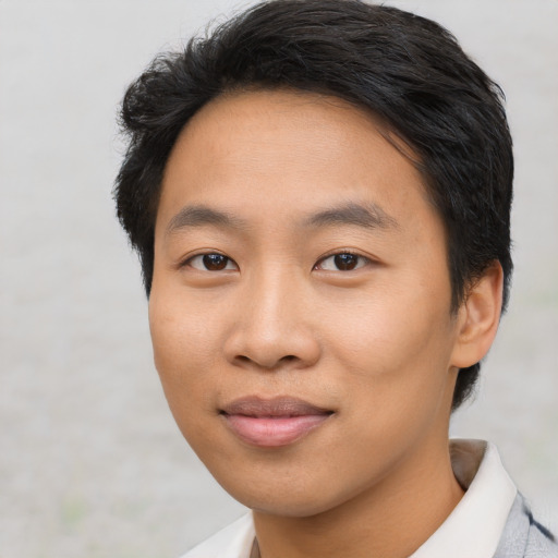 Joyful asian young-adult male with short  brown hair and brown eyes