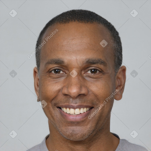 Joyful latino adult male with short  brown hair and brown eyes