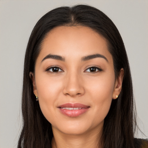 Joyful latino young-adult female with long  black hair and brown eyes