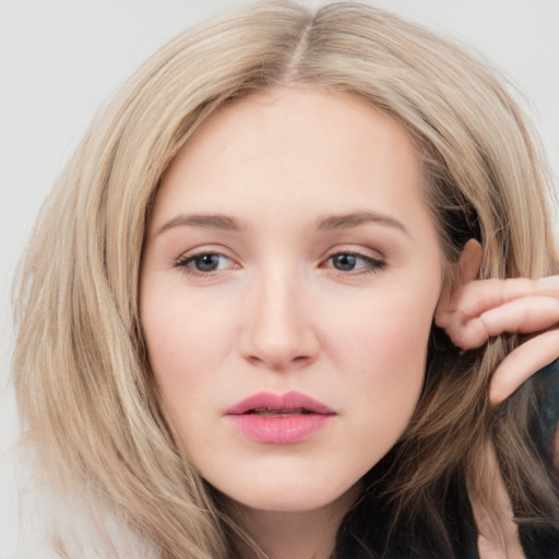 Neutral white young-adult female with long  brown hair and brown eyes