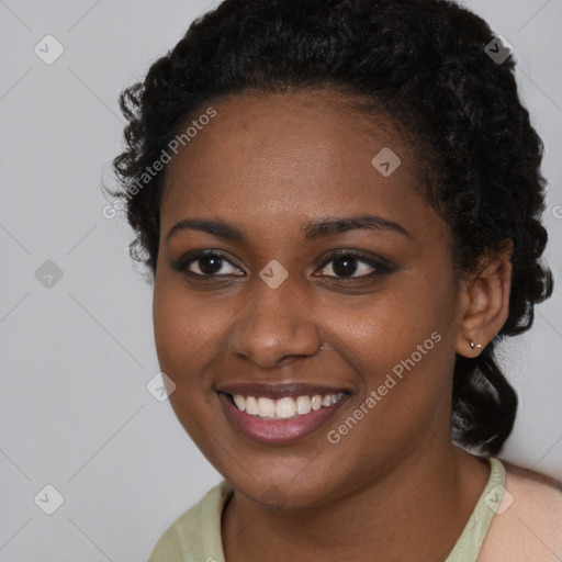 Joyful black young-adult female with long  brown hair and brown eyes