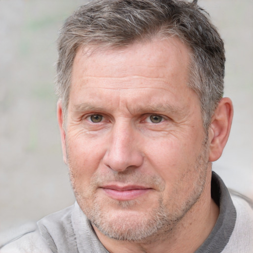 Joyful white middle-aged male with short  brown hair and brown eyes