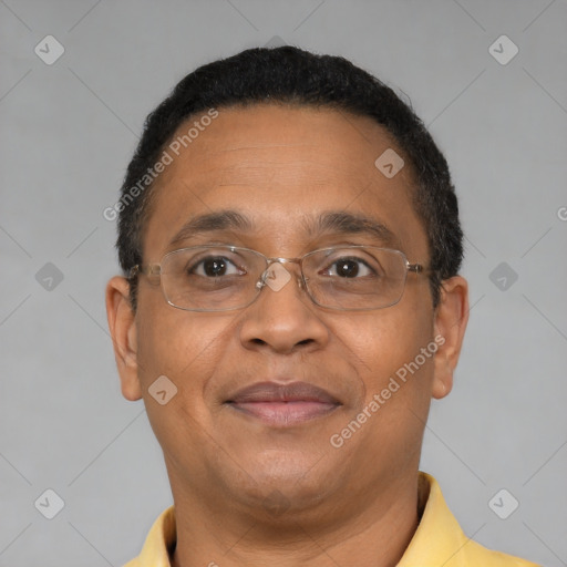 Joyful black adult male with short  brown hair and brown eyes