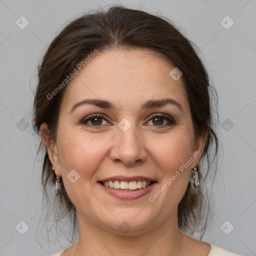 Joyful white adult female with medium  brown hair and grey eyes