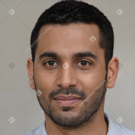 Joyful black young-adult male with short  black hair and brown eyes