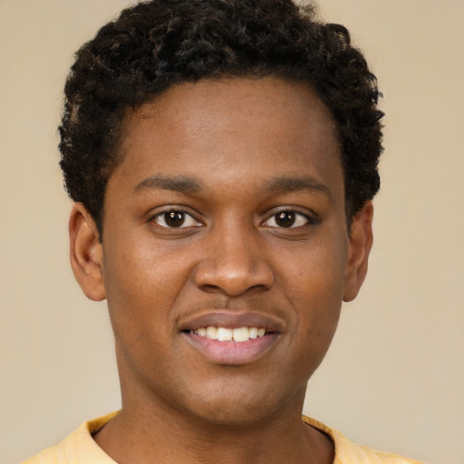 Joyful black young-adult male with short  brown hair and brown eyes