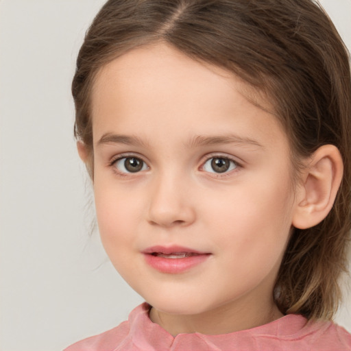 Joyful white child female with medium  brown hair and brown eyes