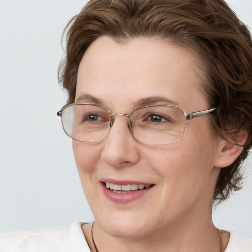 Joyful white adult female with short  brown hair and grey eyes