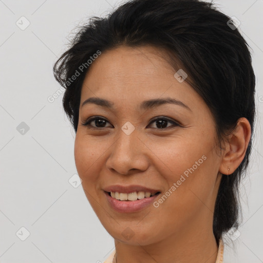 Joyful latino young-adult female with medium  brown hair and brown eyes