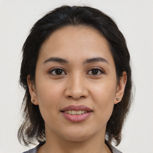 Joyful white young-adult female with medium  brown hair and brown eyes