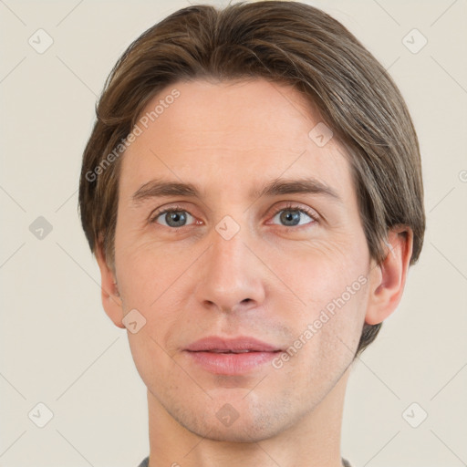 Joyful white young-adult male with short  brown hair and grey eyes