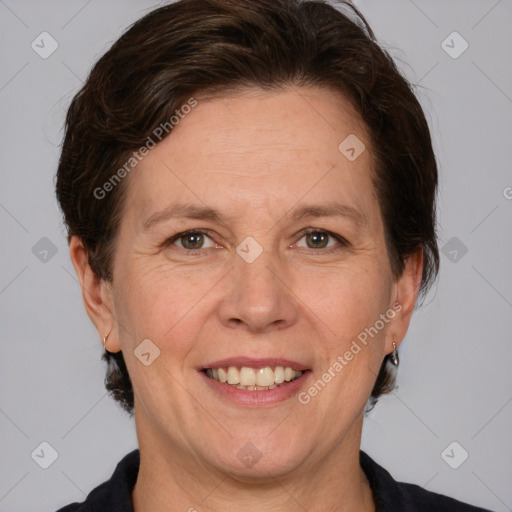 Joyful white adult female with medium  brown hair and grey eyes