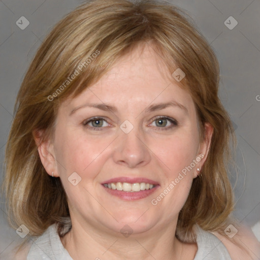 Joyful white adult female with medium  brown hair and blue eyes