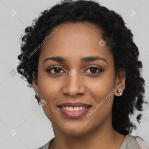 Joyful black young-adult female with long  black hair and brown eyes