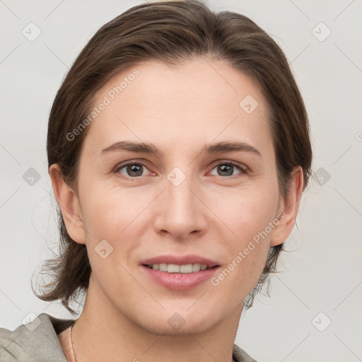 Joyful white young-adult female with medium  brown hair and grey eyes