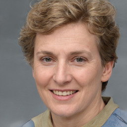 Joyful white adult female with medium  brown hair and blue eyes