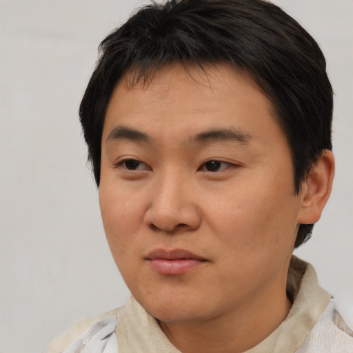 Neutral asian young-adult male with short  brown hair and brown eyes