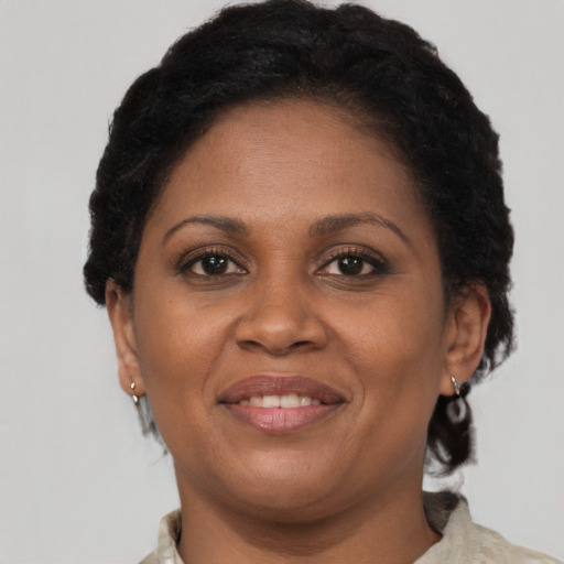 Joyful latino adult female with short  brown hair and brown eyes