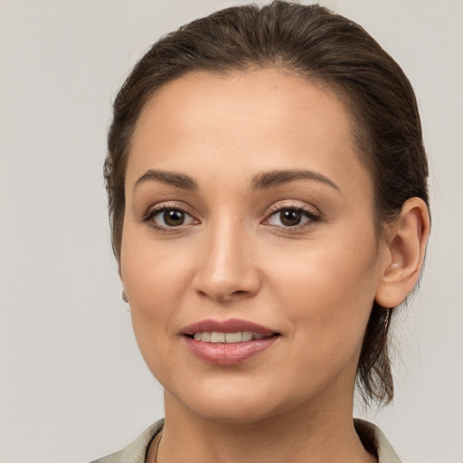 Joyful white young-adult female with medium  brown hair and brown eyes