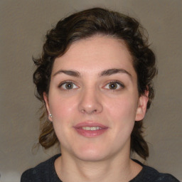 Joyful white young-adult female with medium  brown hair and green eyes